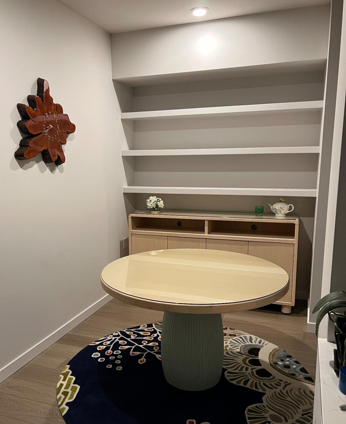 Floating shelves installed in a dining nook, recessed lighting above