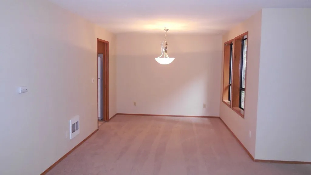Room before build-out — open carpeted space